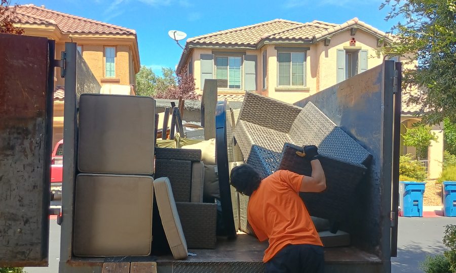 Loading patio furniture and mattresses out of a Las Vegas valley home
